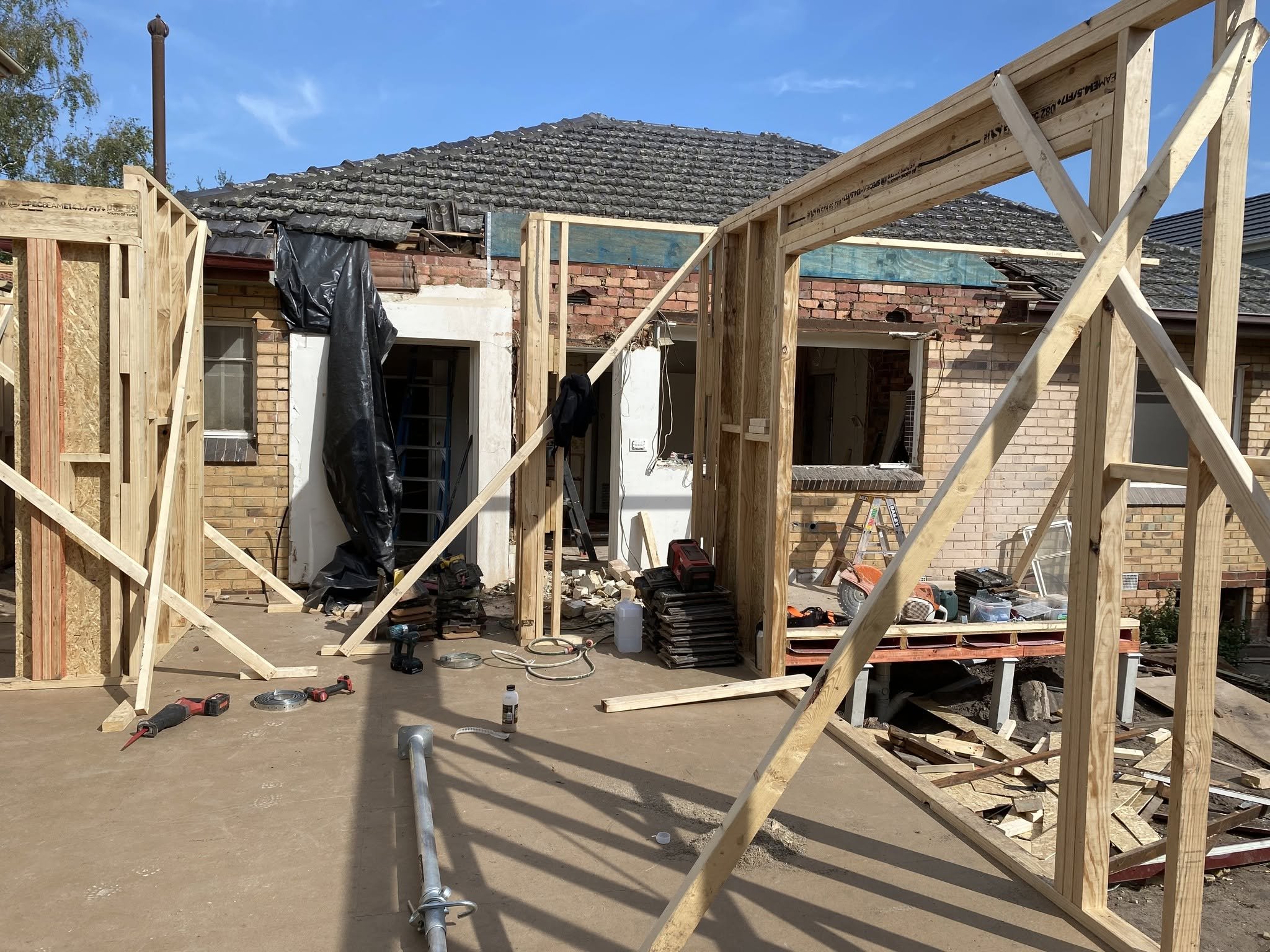 New timber wall frames going up against the original brick home during the McKinnon extension