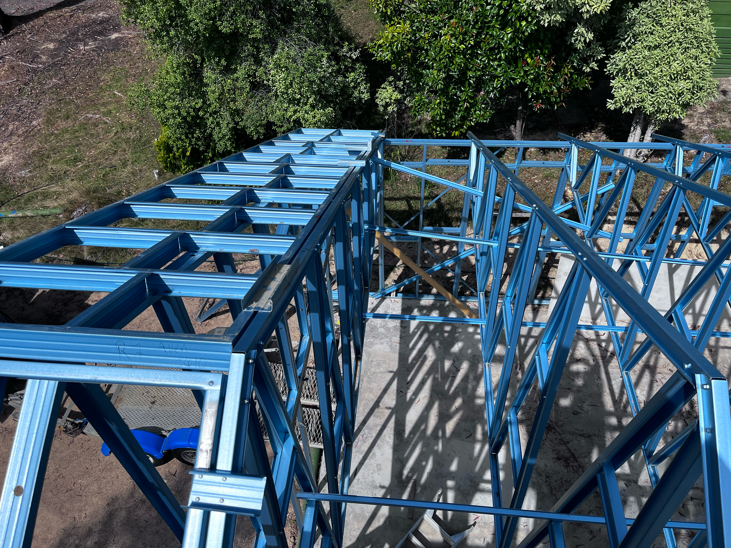 Steel roof trusses and wall frames of the Mansfield Alpine kit home, viewed from above