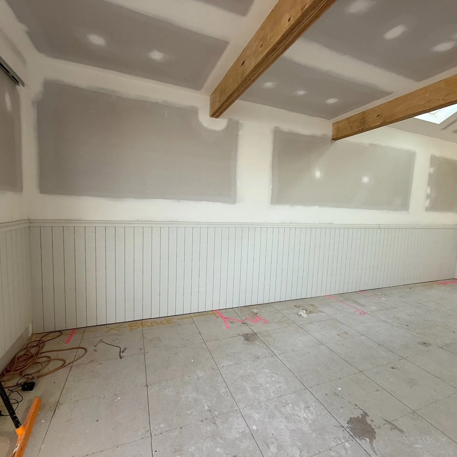 Plastered walls with VJ wall panelling, beach boatshed rebuild