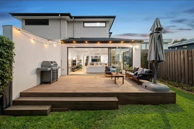 Alfresco deck framed by magnolia trees, Beaumaris North addition