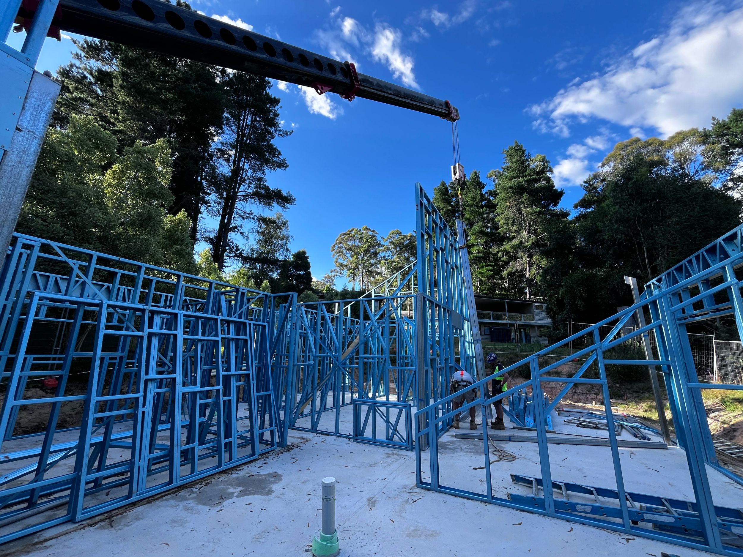 Steel wall frames being craned into place on the slab at the Mansfield Alpine build