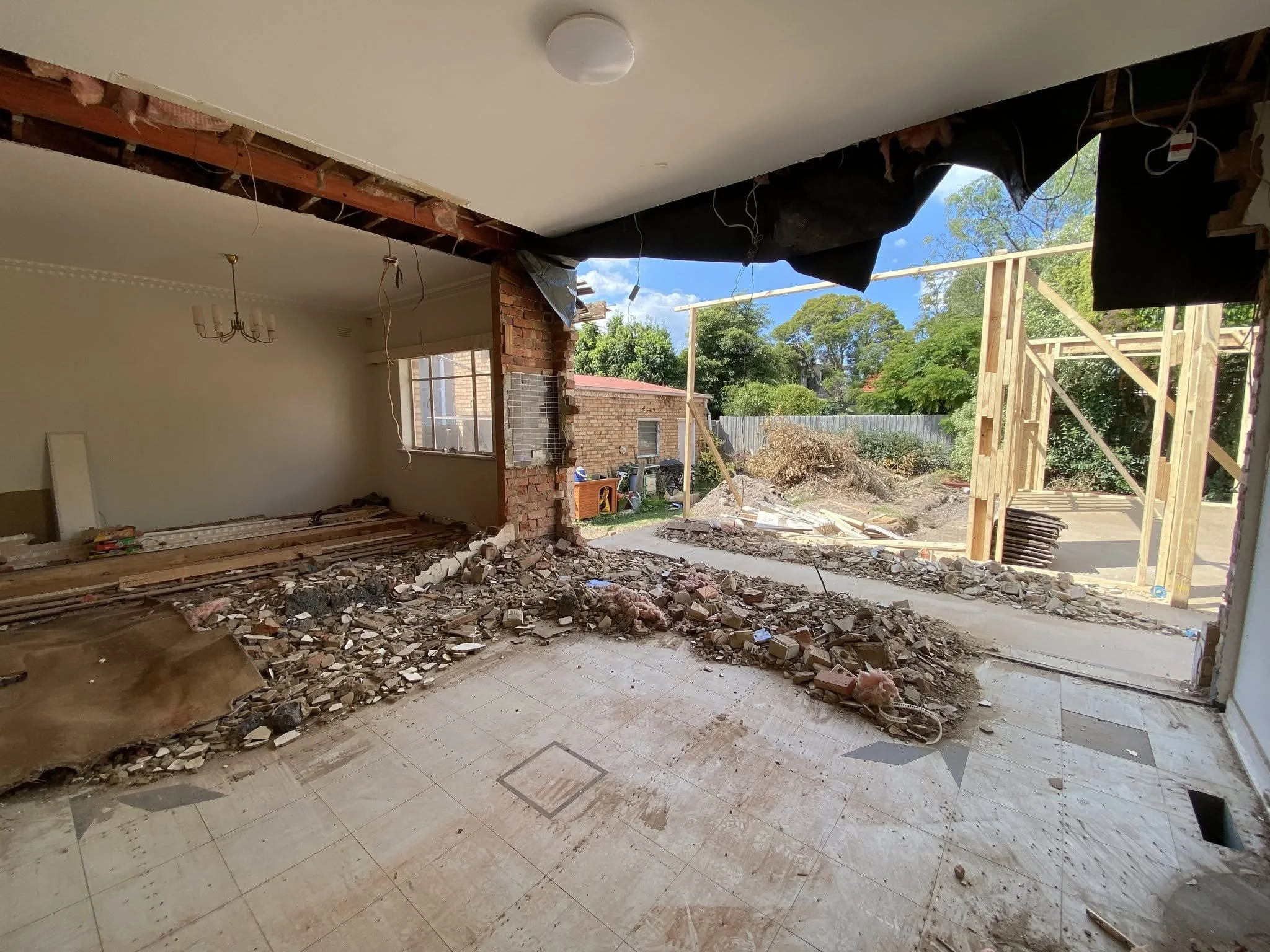 Old rear wall removed in the McKinnon home, opening the original rooms through to the new extension frame