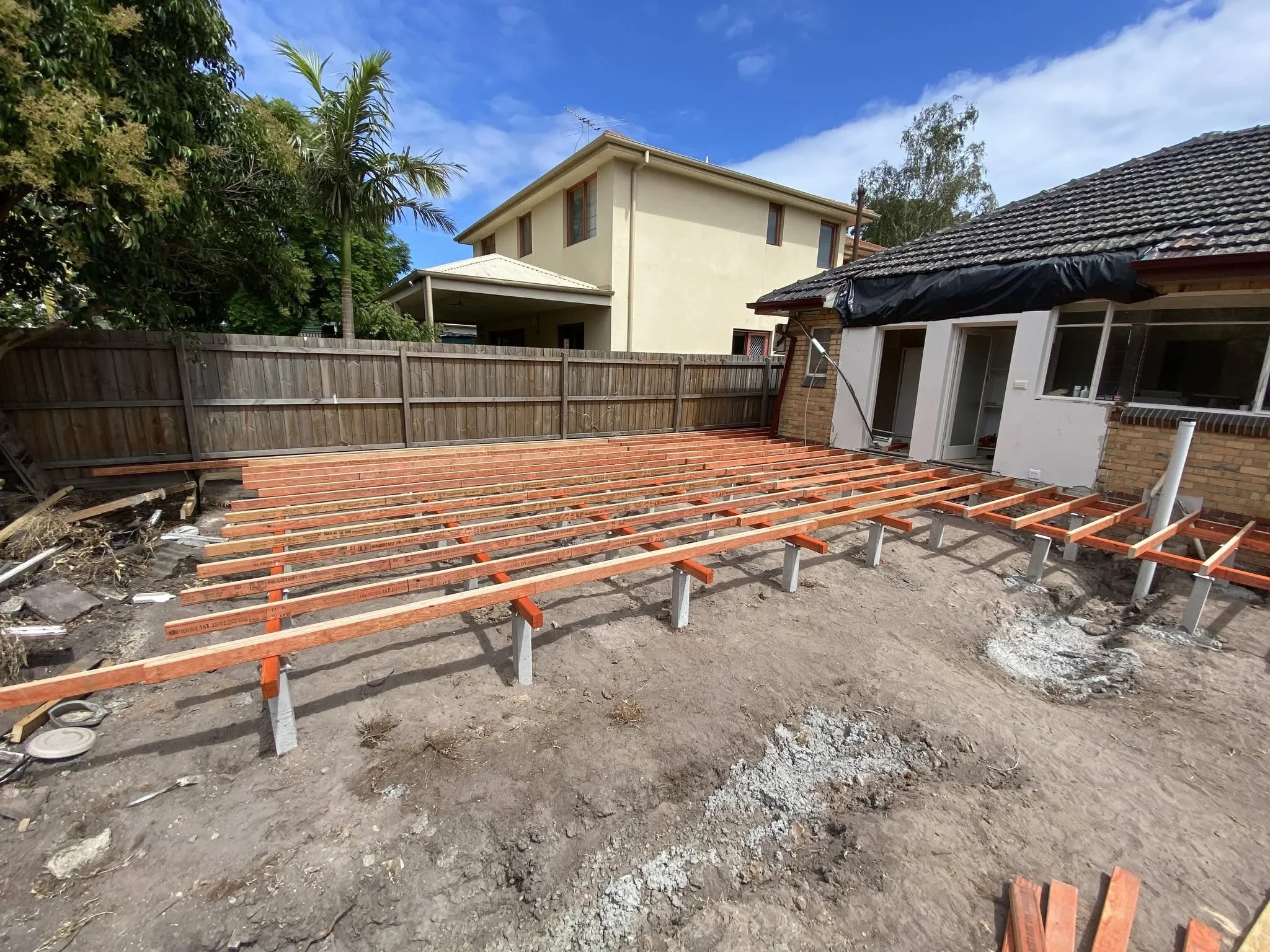 New stump footings and red-primed floor bearers for the McKinnon extension, ready for the floor