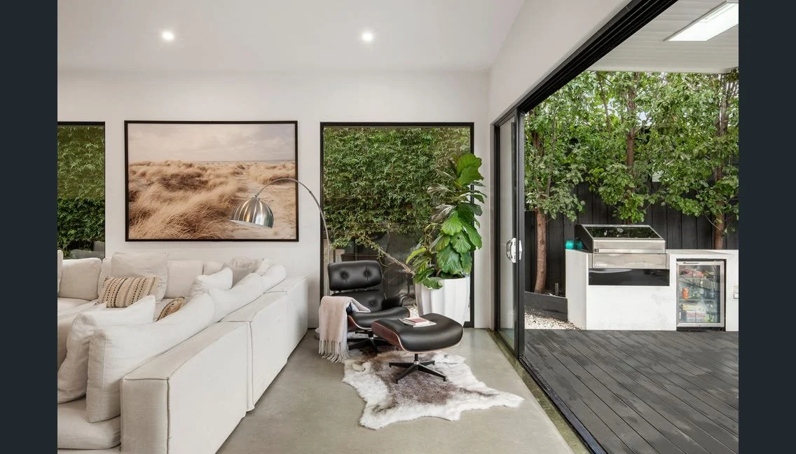 Living room with stacking doors to the deck and outdoor kitchen, Highett renovation