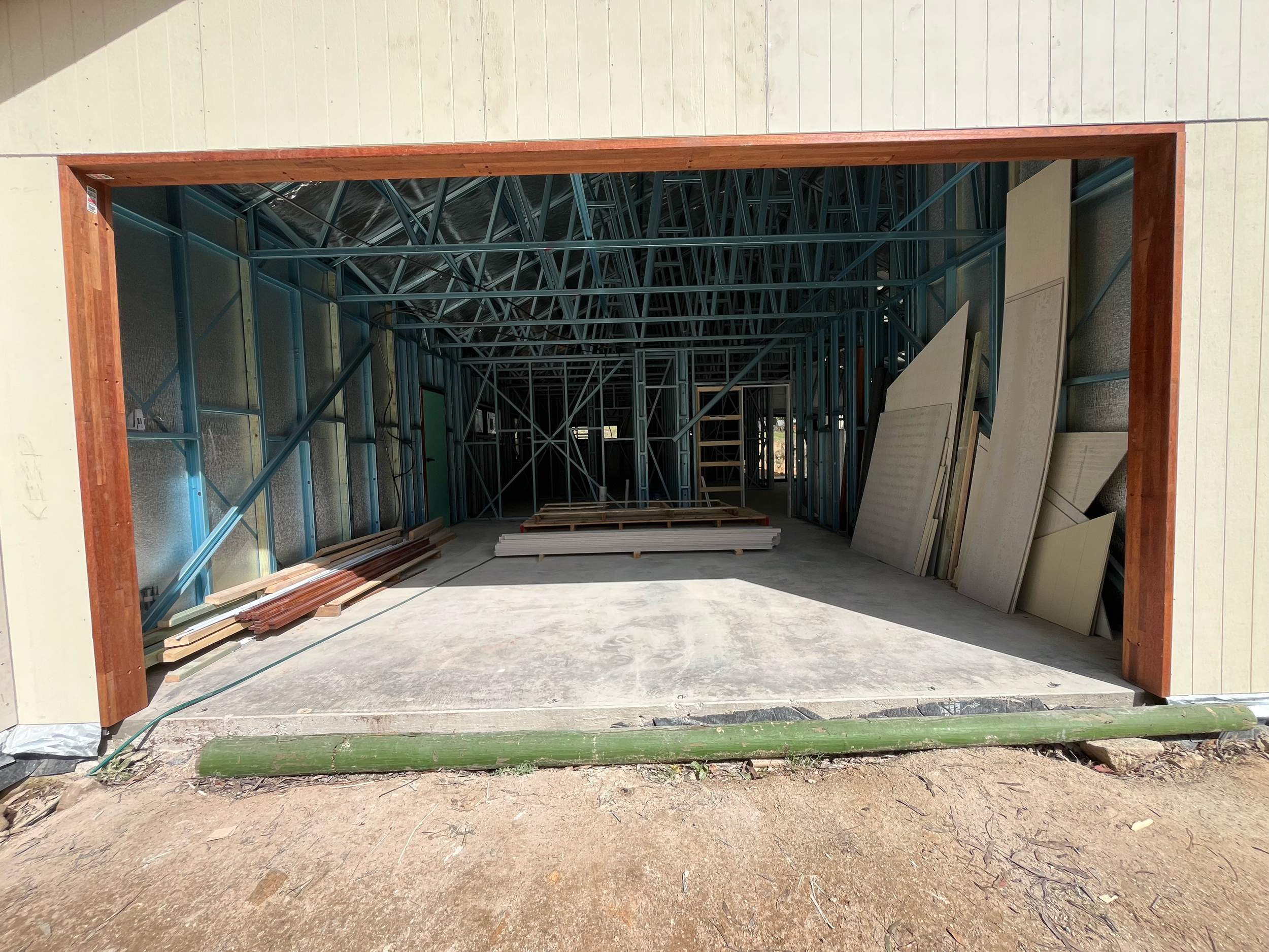 Garage of the Mansfield Alpine home, with the steel frame inside and cladding on the opening