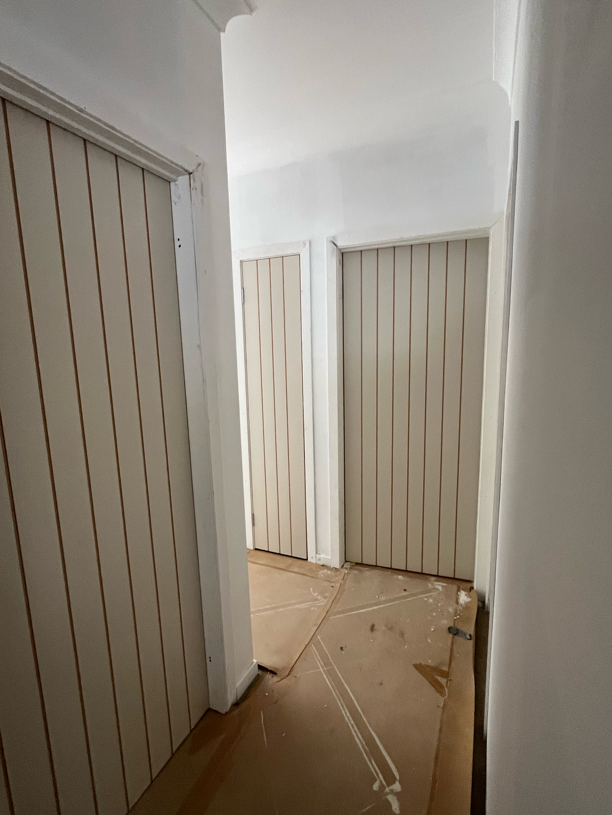 Hallway of the Mansfield Alpine home with timber-look wall panelling and new internal doors