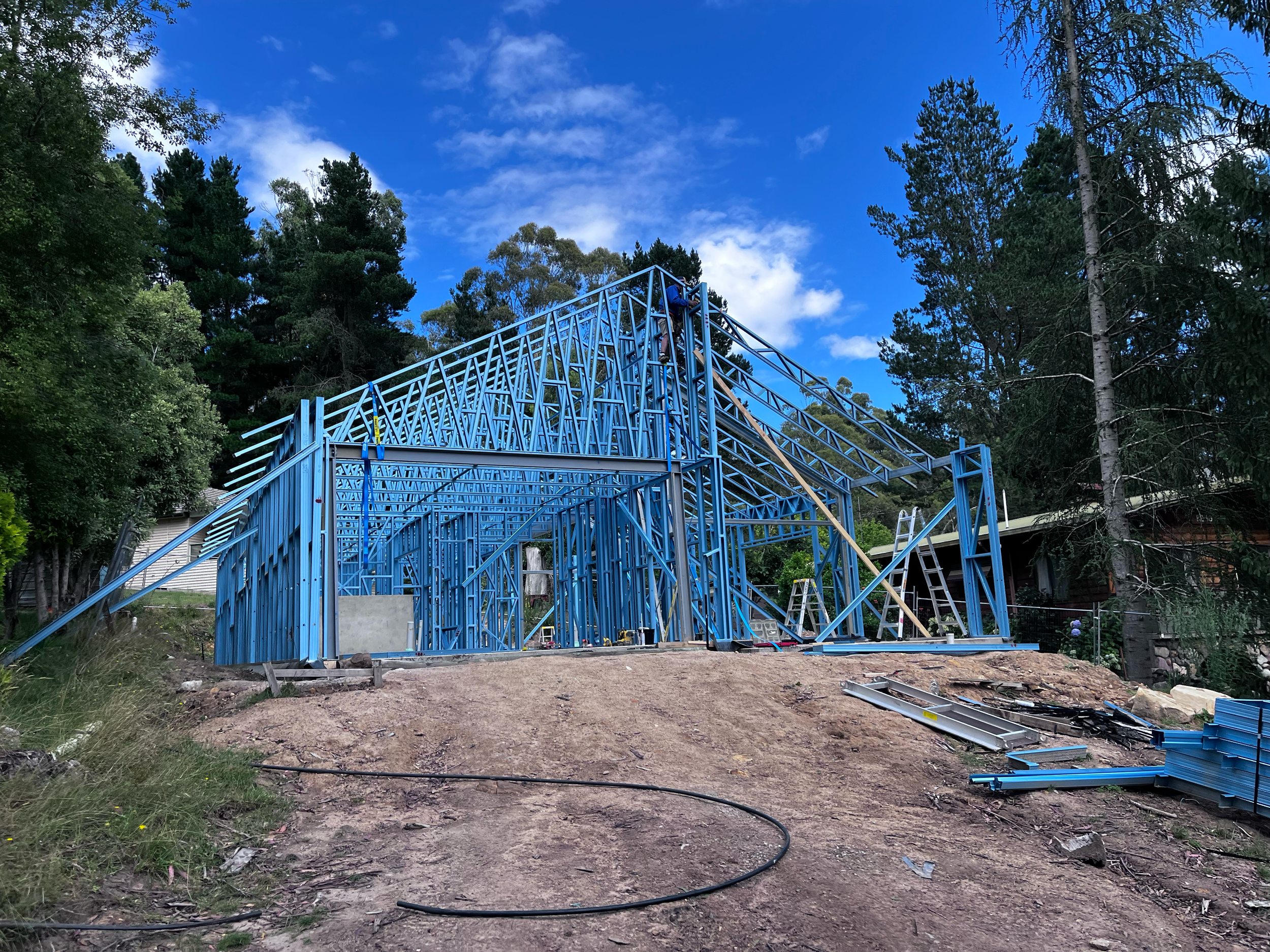 Steel frames and the high-pitched gable taking shape on the Mansfield Alpine kit home