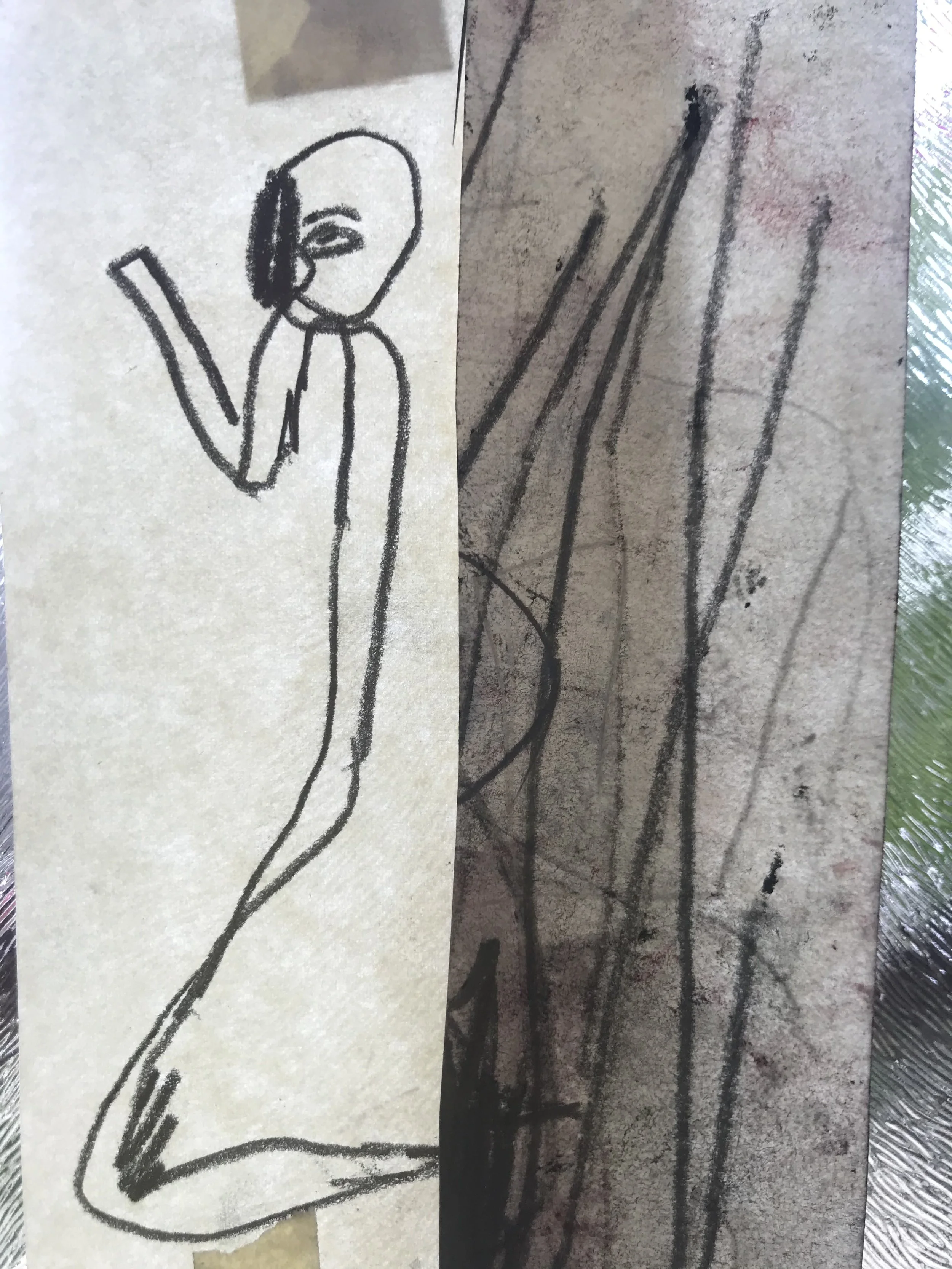 A simple black line drawing of a person with shoulder-length hair, holding a sheet of paper or a book, and standing next to a large potted plant with tall, thin leaves.