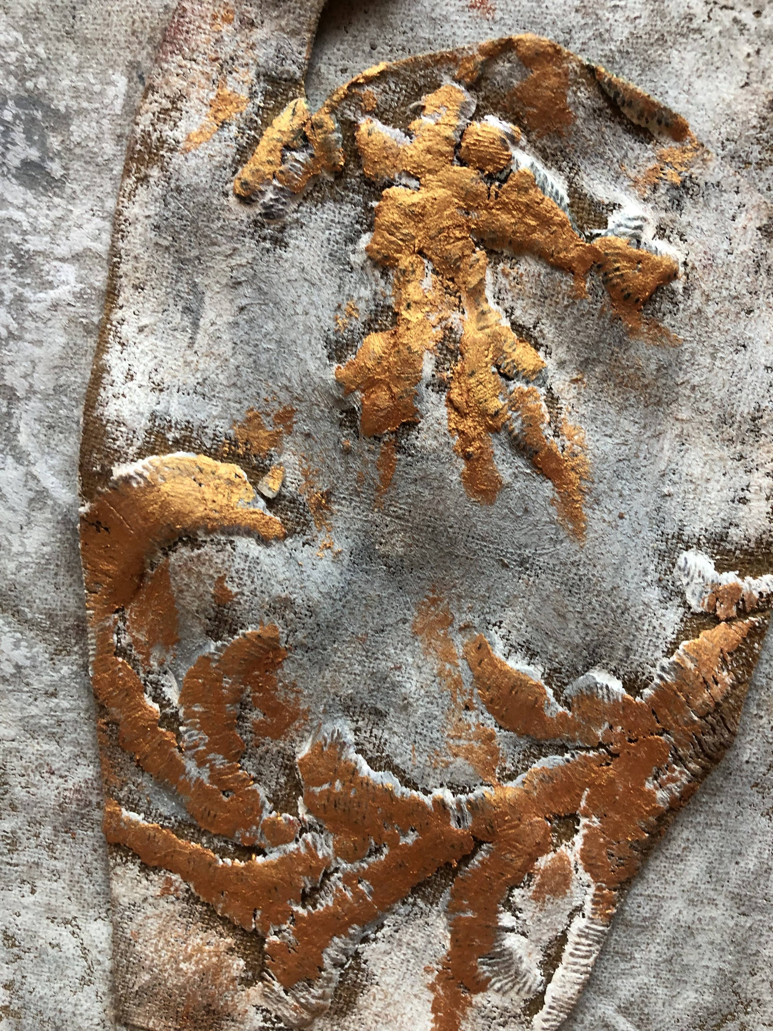 A star-shaped sugar cookie with a textured orange glaze on top, lightly dusted with powdered sugar, on a floured surface.