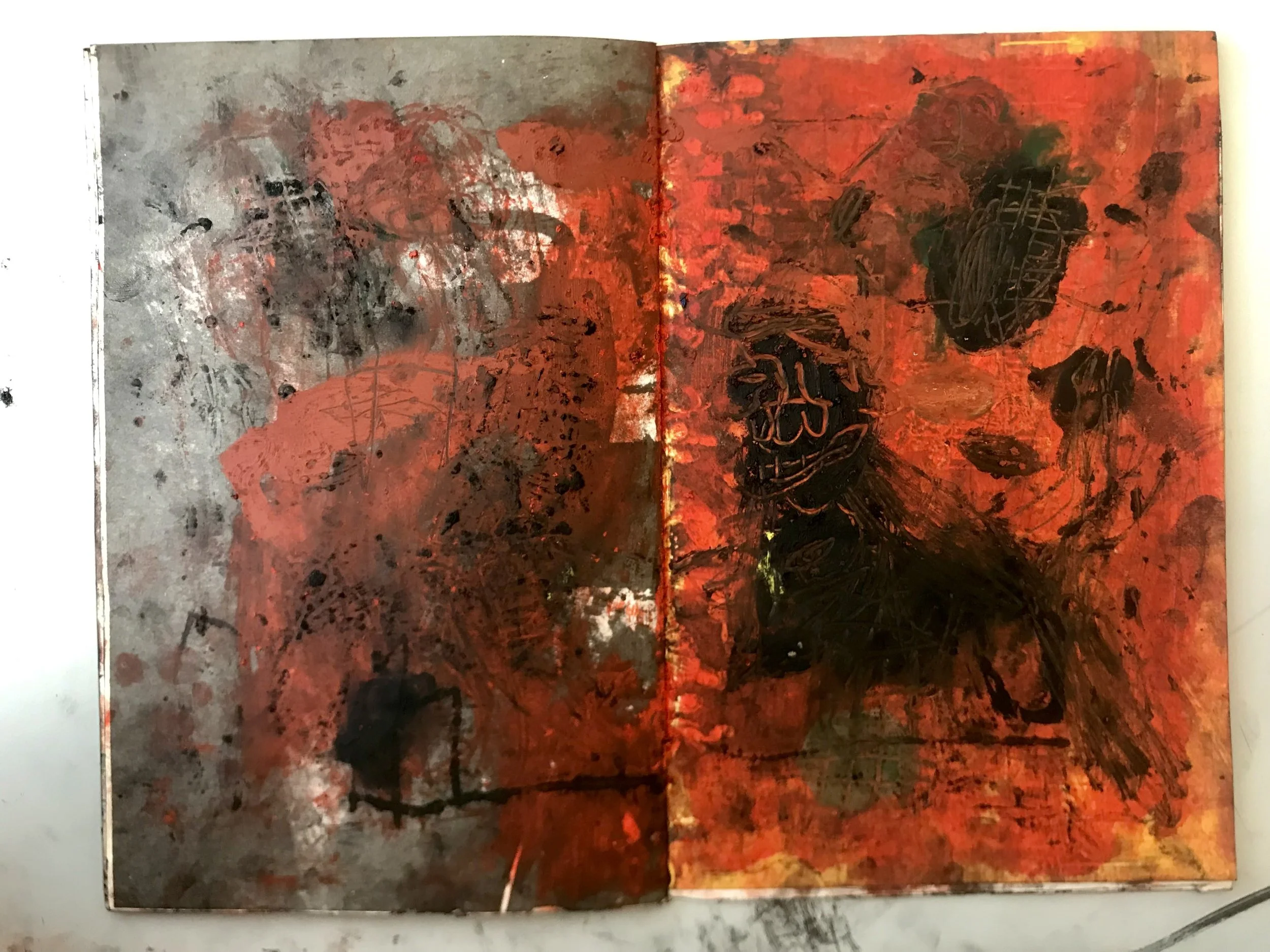 An abstract painting with splashes of red, black, and gray paint on a textured surface.