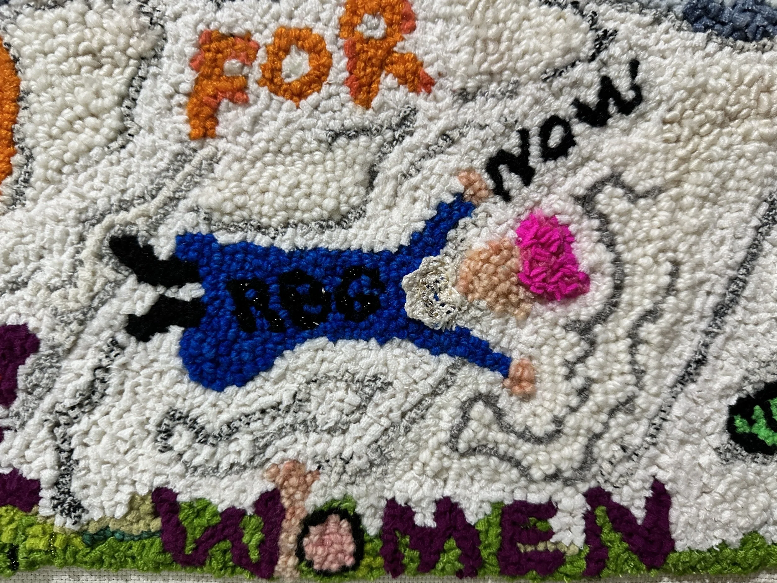 Close-up of a texture rug design on a white fabric background.