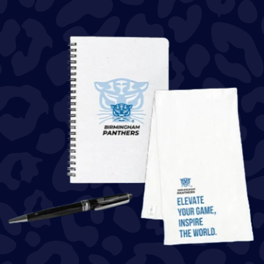 Birmingham Panthers branded spiral notebook, motivational notepad, and black pen on a dark patterned background