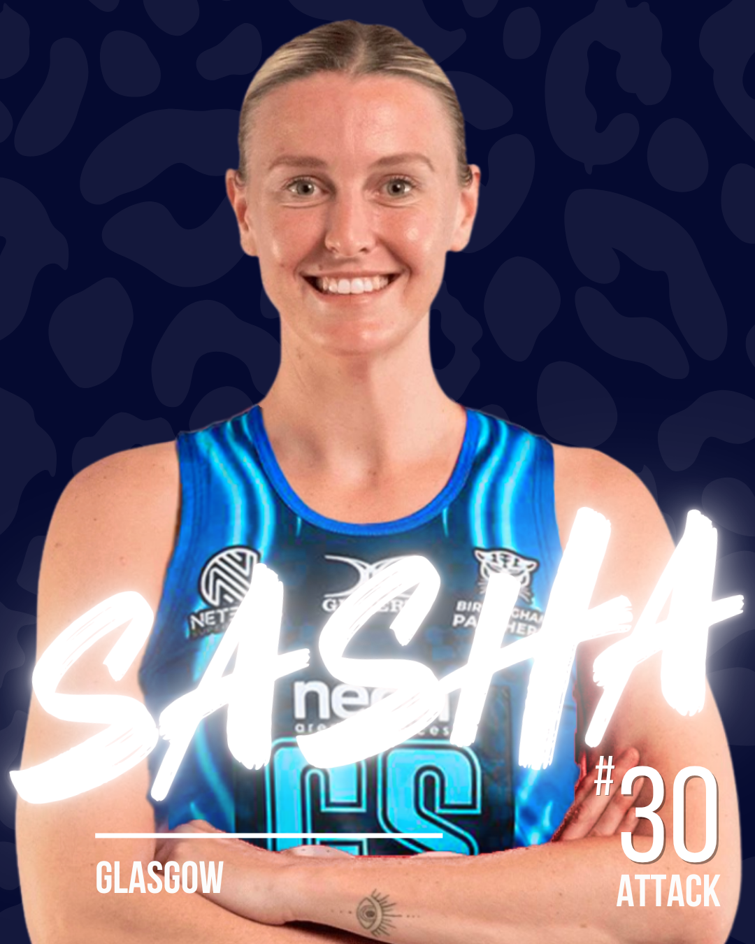 A netball player in a blue netball dress, smiling with arms crossed, with team logos and her name 'Sasha' visible, set against a dark patterned background.