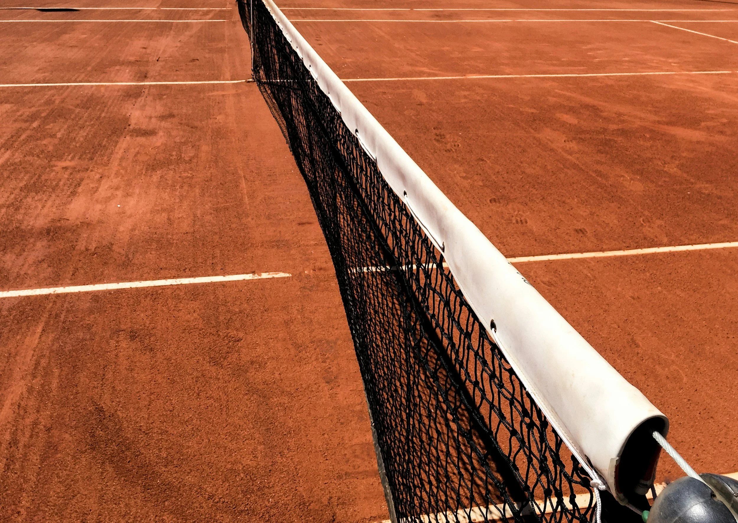 Close-up of a tennis court net, representing focus, precision, and performance in sport.