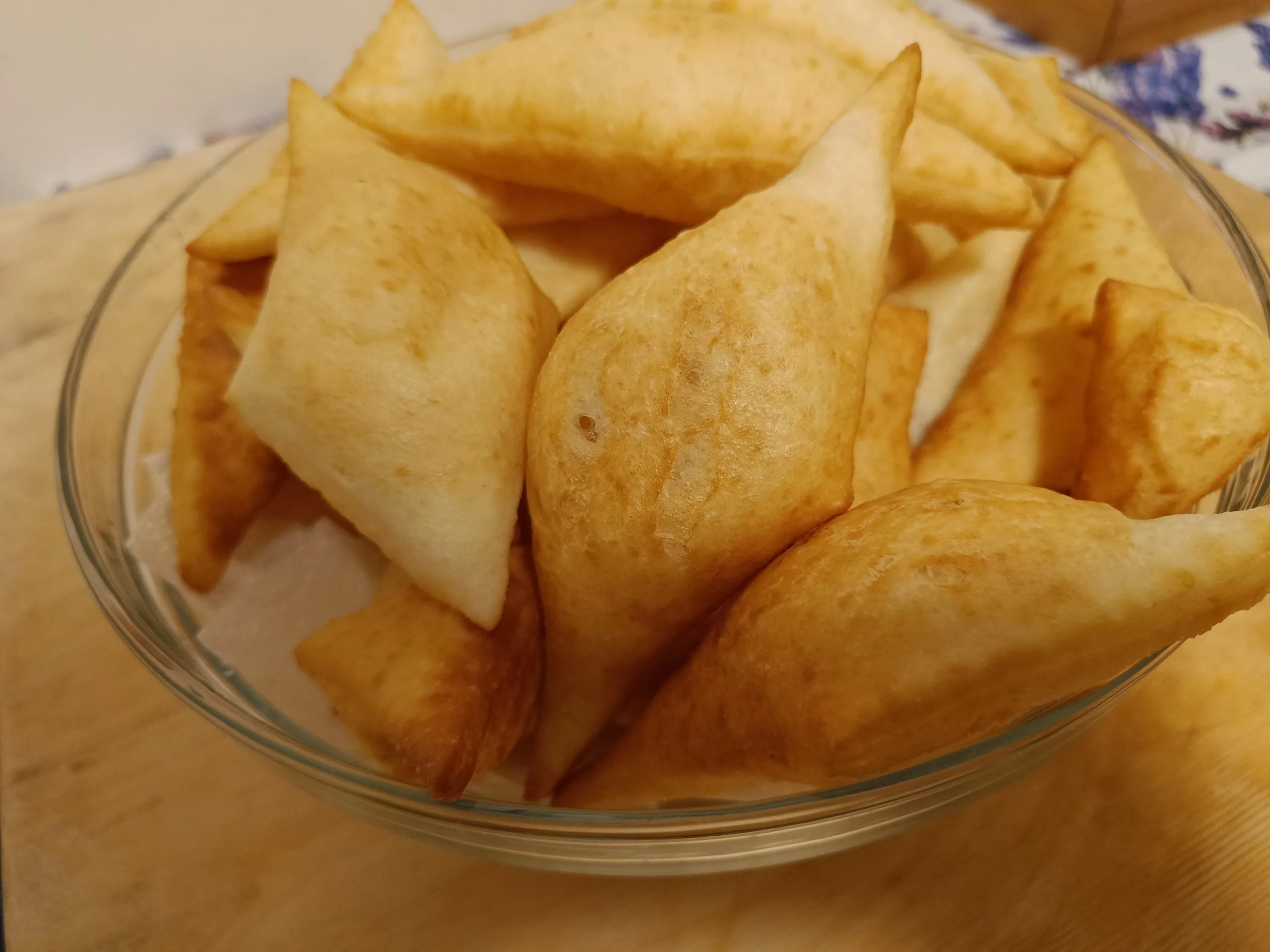 Gnocco fritto, fried pieces of Italian dough from Emilia-Romagna, served in a glass bowl.