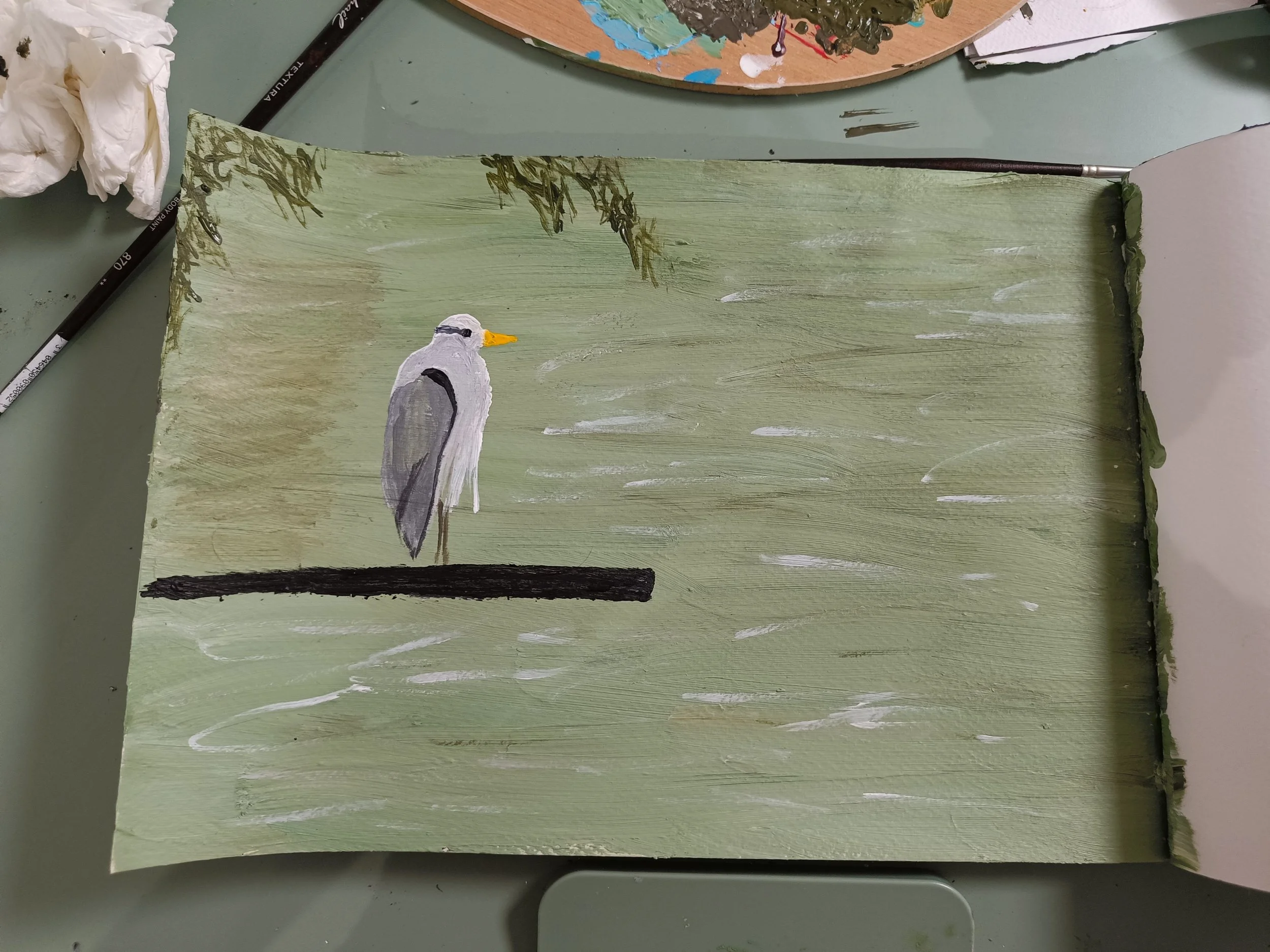 “Heron in Stillness,” an acrylic painting by Chaya showing a heron standing beside water, with trees and sky in the background.