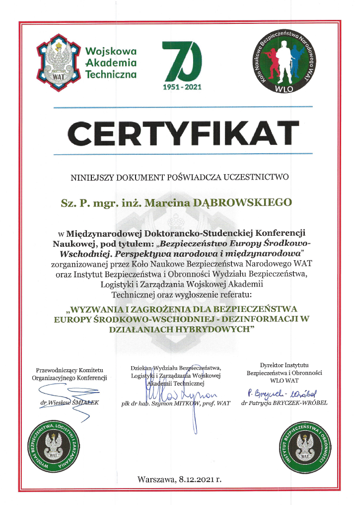 Certificate with logos at the top, including Wojskowa Akademia Techniczna, a 70th anniversary logo, and the National Security and Defense Institute logo. Text in Polish certifies participation in an international scientific conference on security and hybrid activities, dated December 8, 2021, in Warsaw.