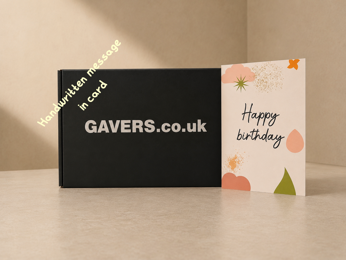 Black gift box with white text 'GAVERS.co.uk' and a birthday greeting card with artistic design and 'Happy birthday' message.