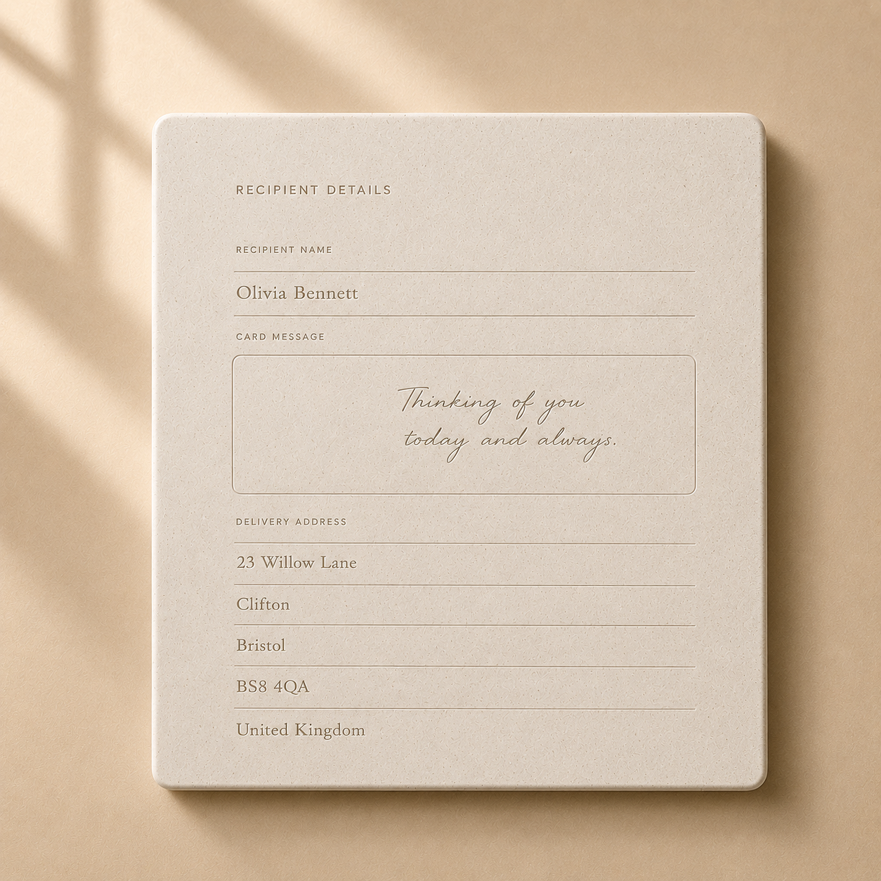 A beige card with recipient details, including the name Olivia Bennett, and a message saying, "Thinking of you today and always." Delivery address at 23 Gavers Lane, Clifton, Bristol, UK.