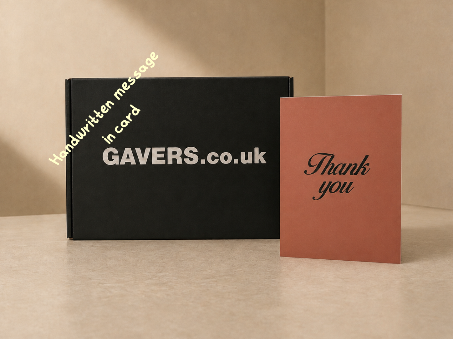 Black box with white text reading "GAVERS.co.uk" and yellow text saying "Handwritten message in card" next to a pink thank you card with black cursive writing.
