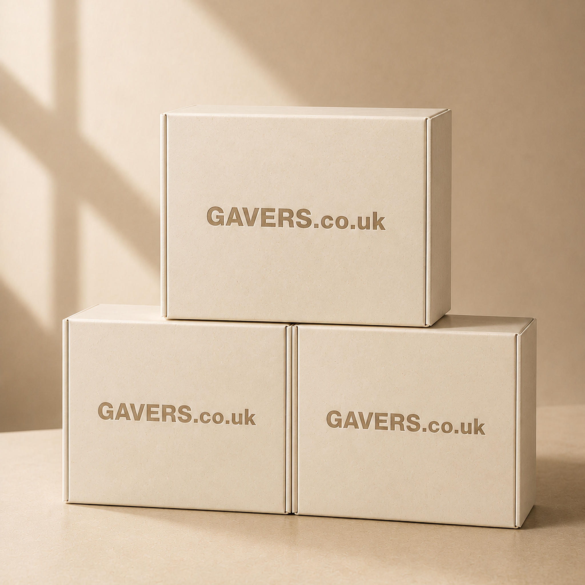 Stacked beige cardboard boxes with GAVERS.co.uk printed on the front, on a beige surface against a beige background.