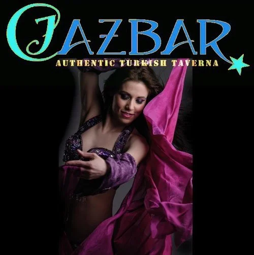 Sign for Jazbar, an authentic Turkish tavern, with a woman in traditional Turkish dance attire holding a pink scarf.