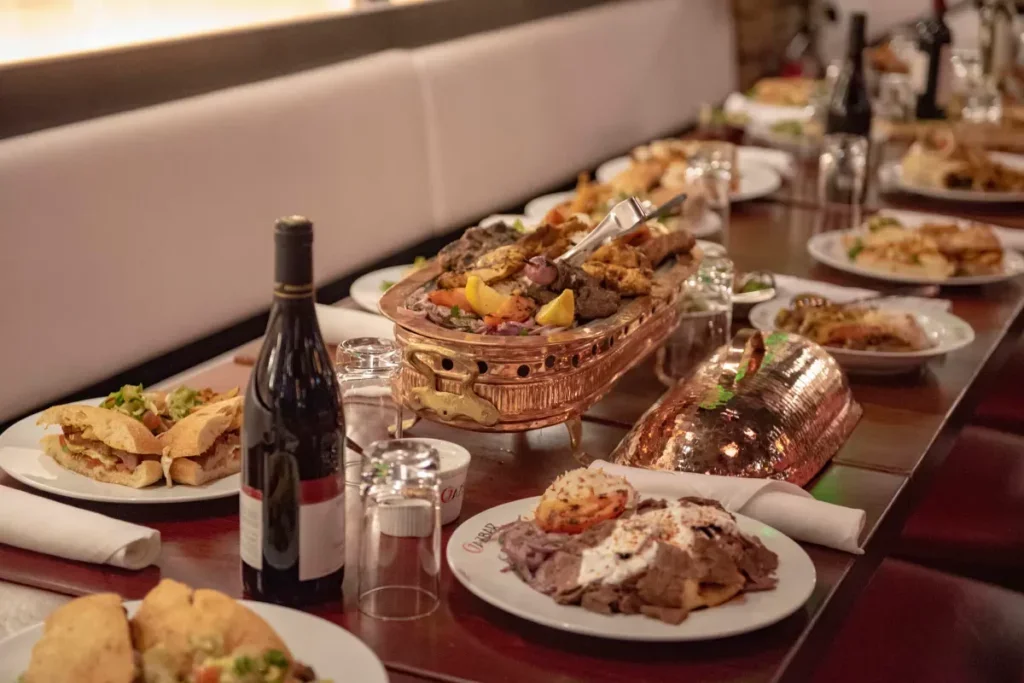 A shared Turkish feast with platters of grilled meats and appetizers at Cazbar.