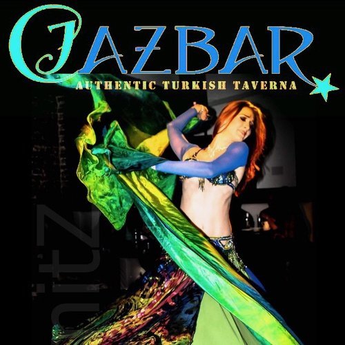 Sign for Jazbar Turkish Taverna with a belly dancer performing on stage.