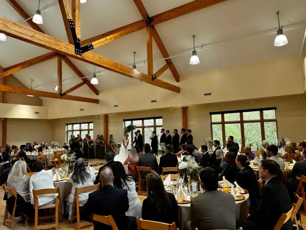 Guests seated at round tables for a catered wedding celebration.