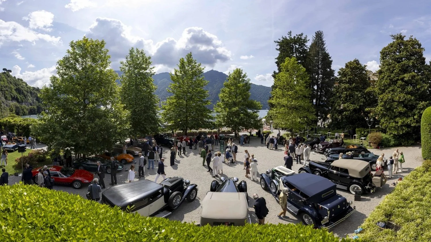 Pictures of various classic cars in a large car park of a fancy mansion in lake como italy