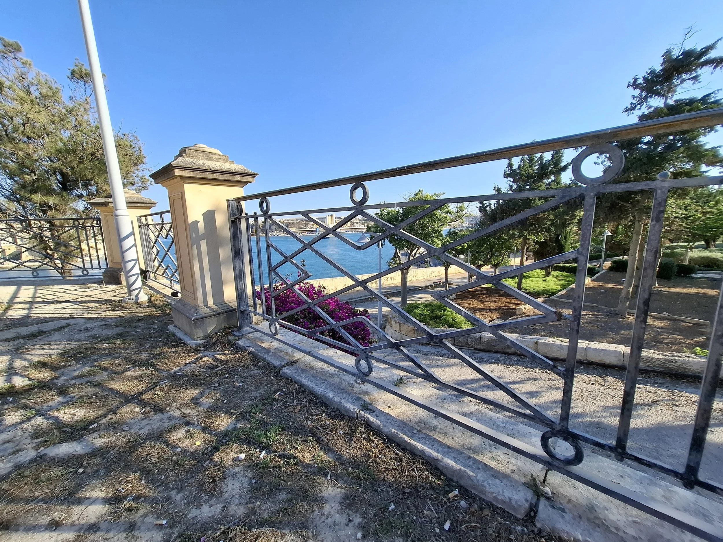 Pink flowers fencing sea.jpg