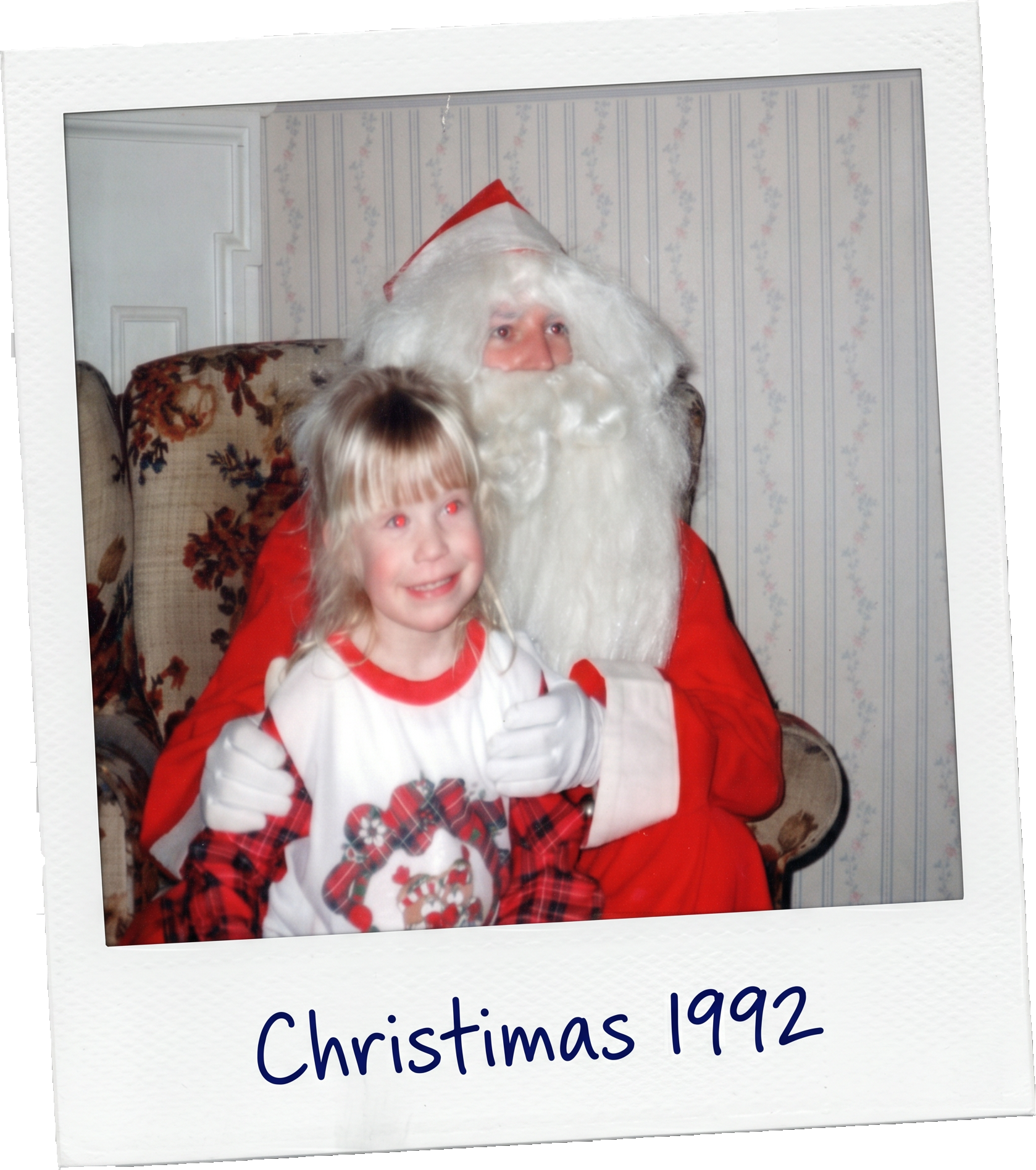 A young girl in Christmas pajamas sitting on Santa Claus's lap during a 1992 Christmas visit, with Santa wearing a traditional red suit and a white beard, in a cozy room with floral wallpaper.