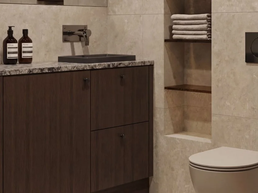 Bathroom detail with stacked towels in a niche and a wall-mounted toilet.