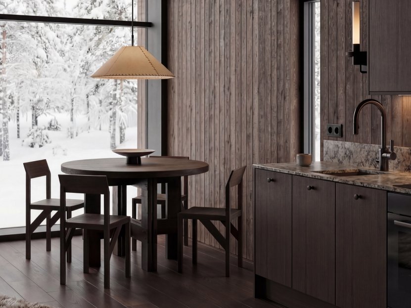 Dining table for four next to a floor-to-ceiling window facing snow-covered trees.