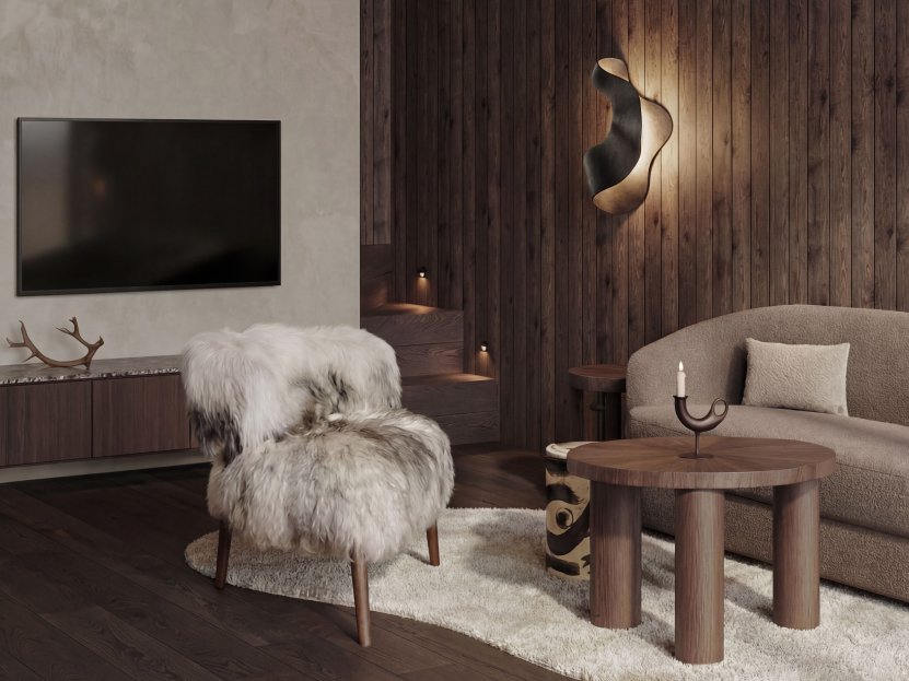 Cosy living room with wall-mounted TV, sheepskin lounge chair and warm wood panelling.