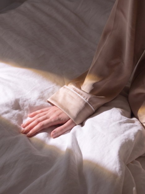 Woman touching a lush blanket with linen duvet