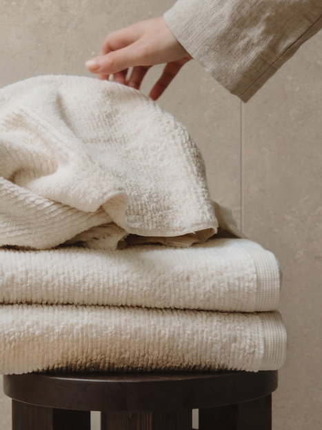 Woman reaching out for a fresh towel