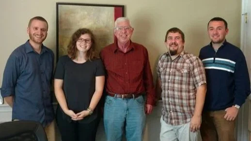 Garth with Parma. Pictured: Chris Robinson, Samantha Granville, Garth Baxter, Brett Picknell and Patrick Niland.