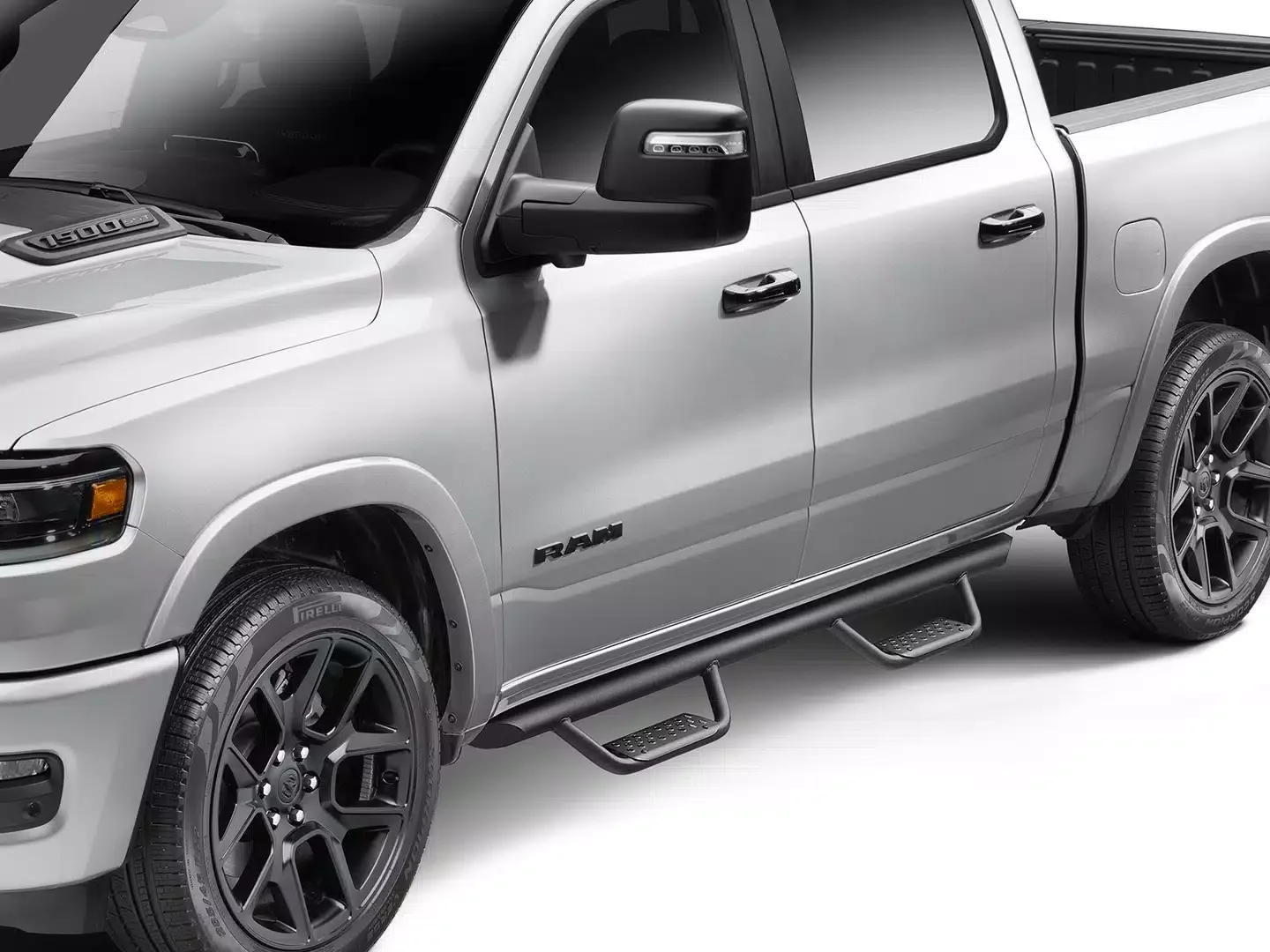 Silver RAM pickup truck with black wheels, running boards, and side mirrors, showing the front and side view.