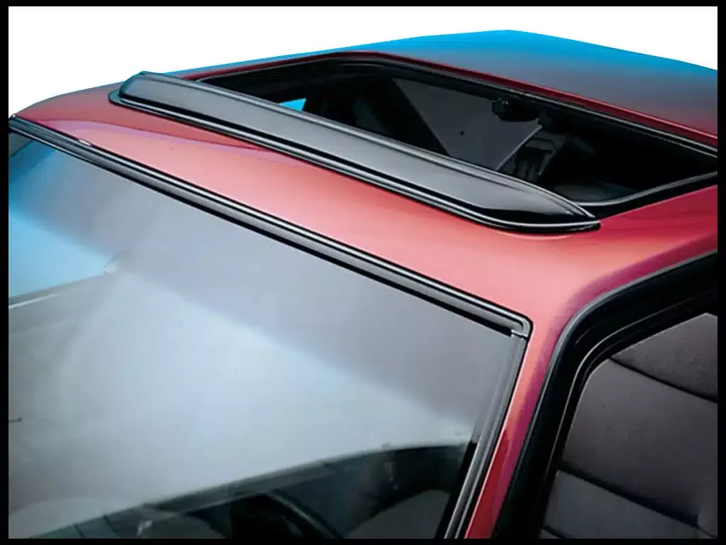 Close-up of a car's sunroof and windshield, featuring a red and black color scheme.