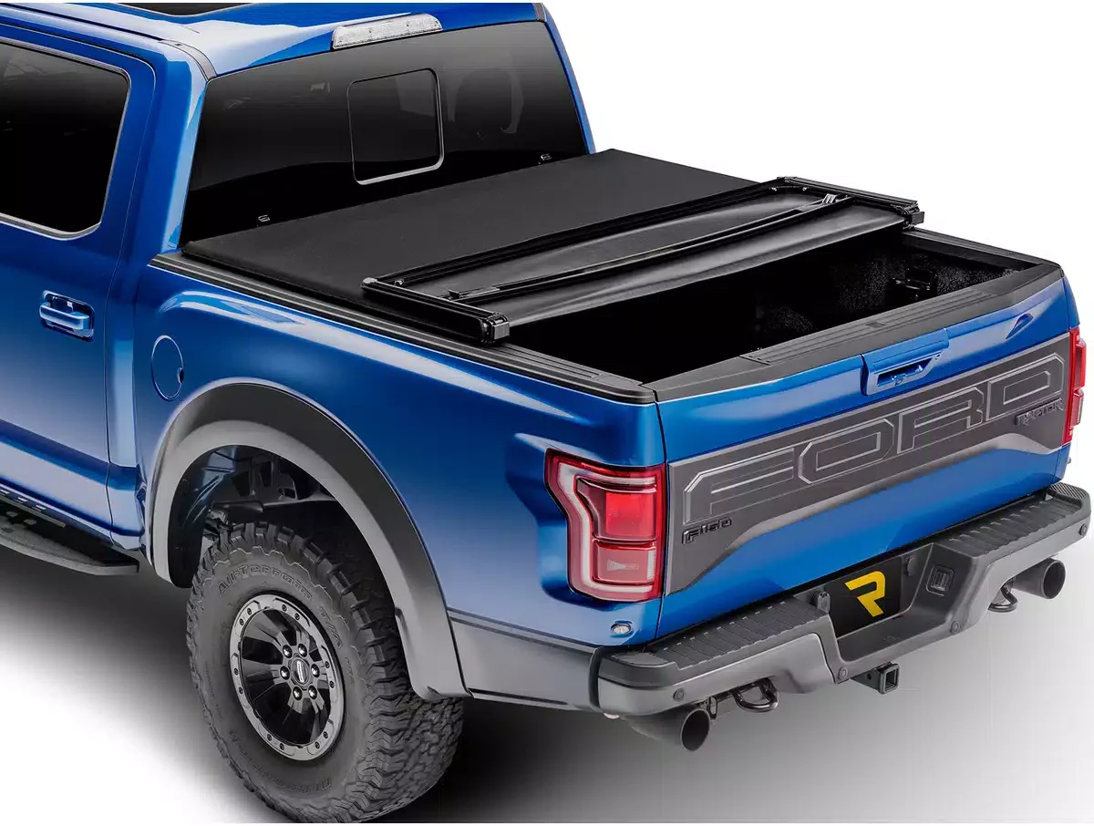 Blue Ford pickup truck with a black tonneau cover over the truck bed.