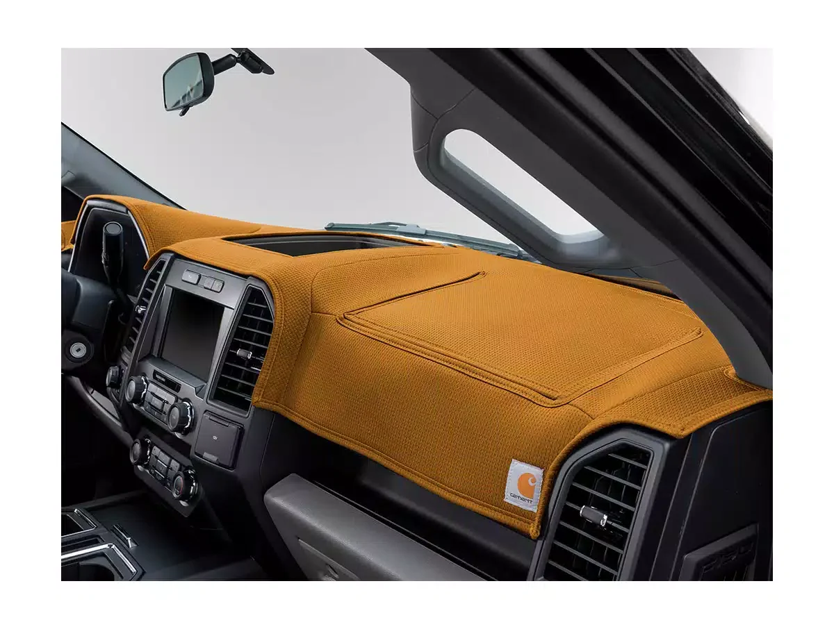 The interior of a vehicle with a Carhartt-designed orange dashboard cover over the dashboard.