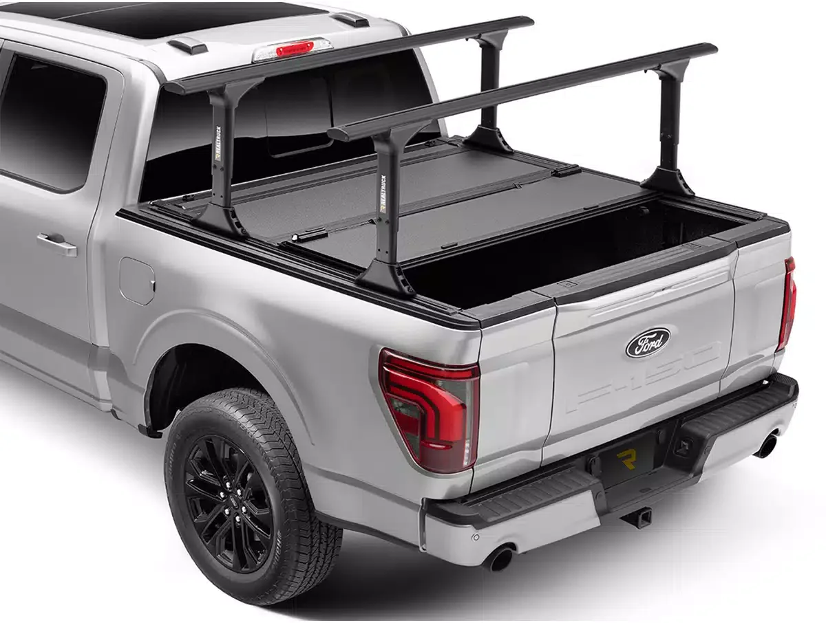 Silver Ford pickup truck with a black adjustable roof rack installed in the truck bed.