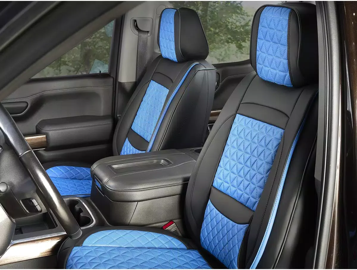 Inside a vehicle showing the front and back seats with black and blue diamond-stitched seat covers.