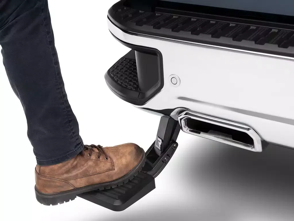 Person stepping onto a vehicle with a built-in foot pedal for easy entry