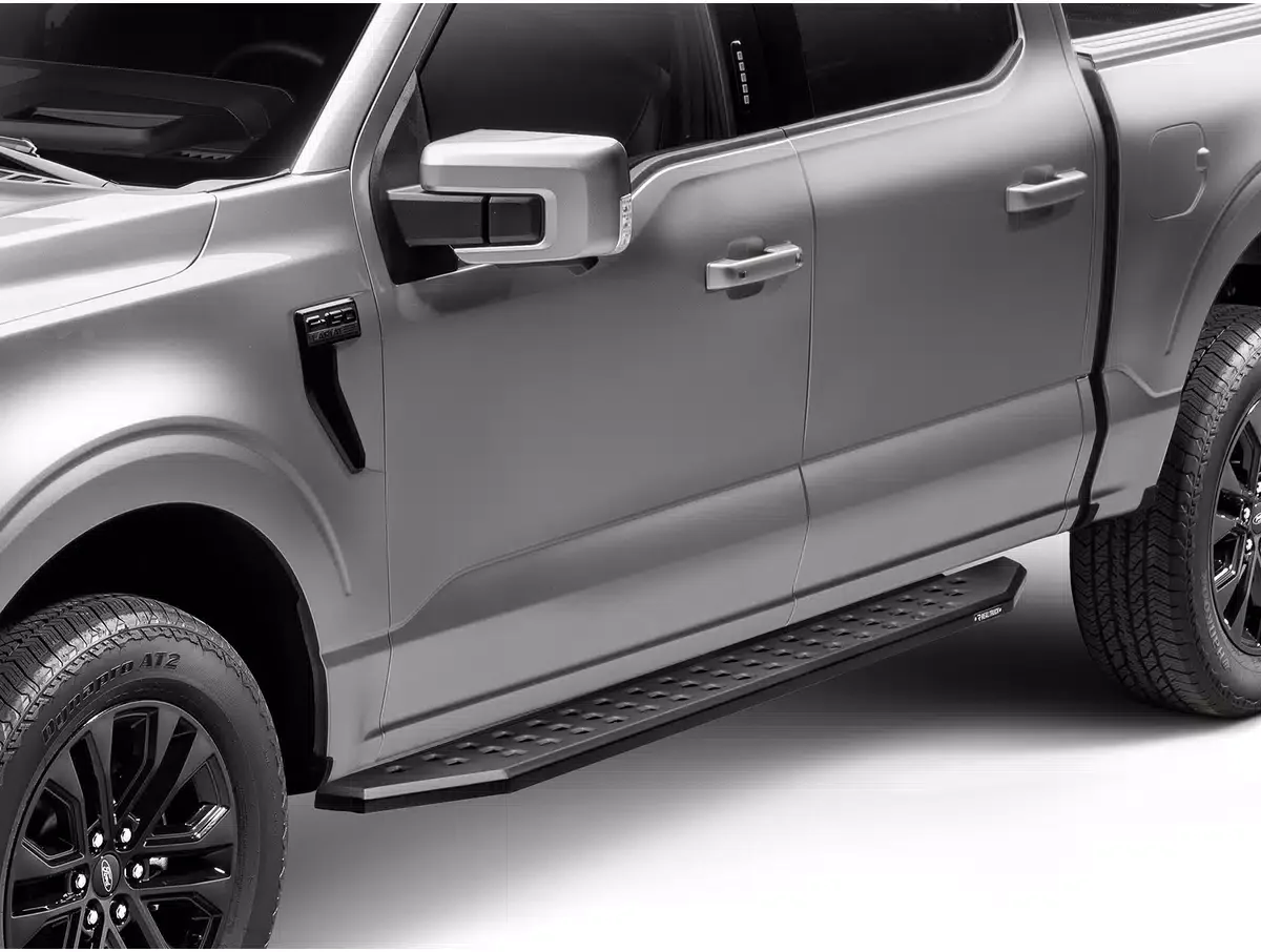 Side view of a silver pickup truck showing front and rear doors, side mirror, running board, and tires.