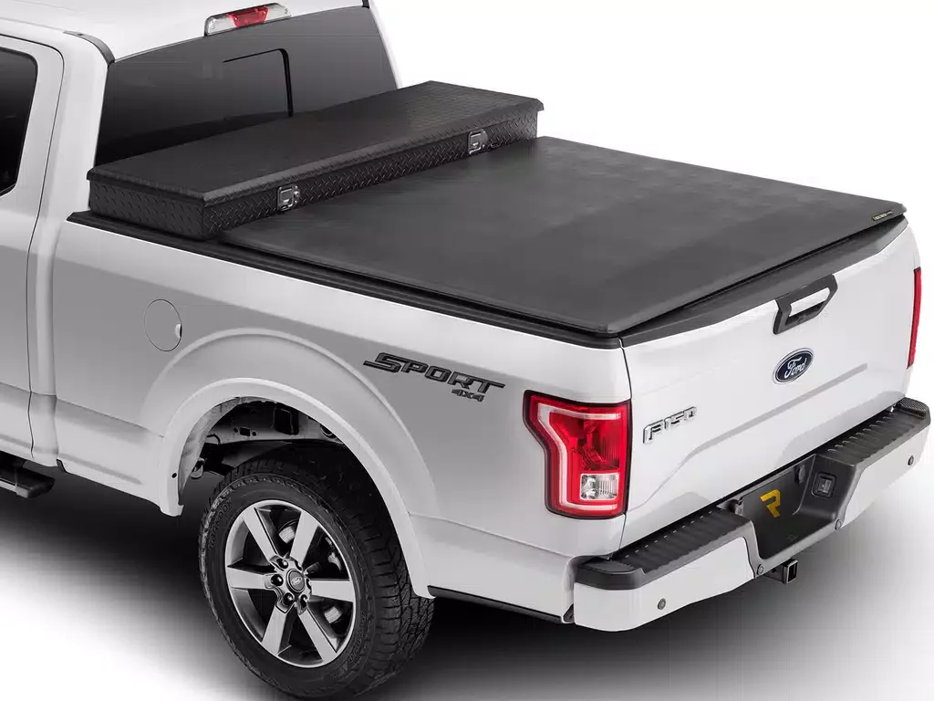 Ford F-150 pickup truck with a covered truck bed and a black canopy in the back.