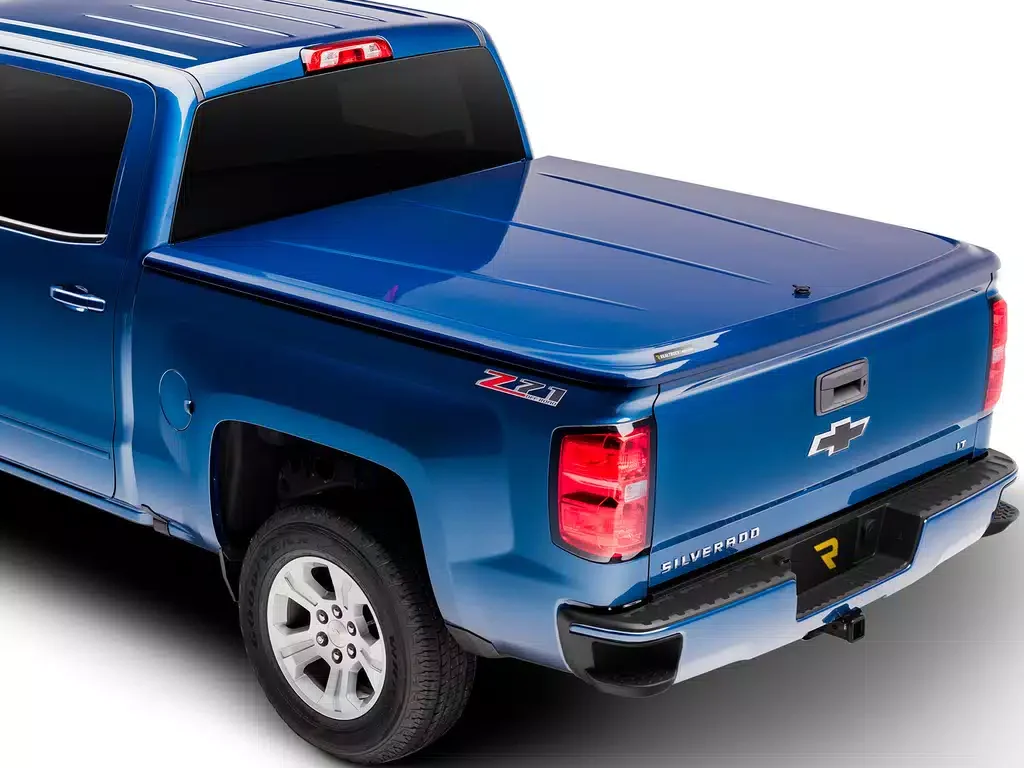 A blue Chevrolet Silverado pickup truck with a Z71 off-road package, a tonneau cover on the bed, and a trailer hitch, parked on a white background.