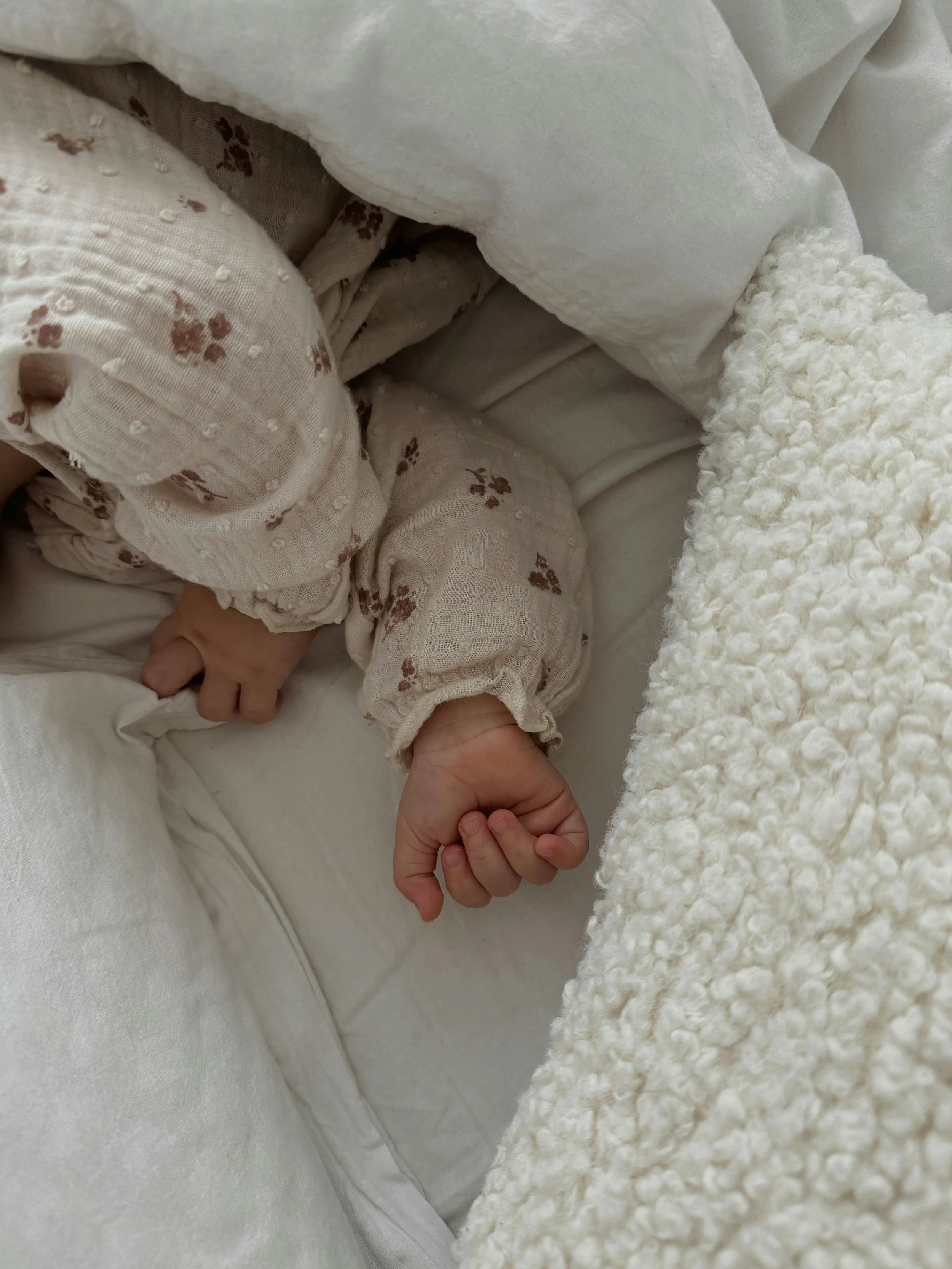 Baby asleep and cosy in blankets, well rested in bed