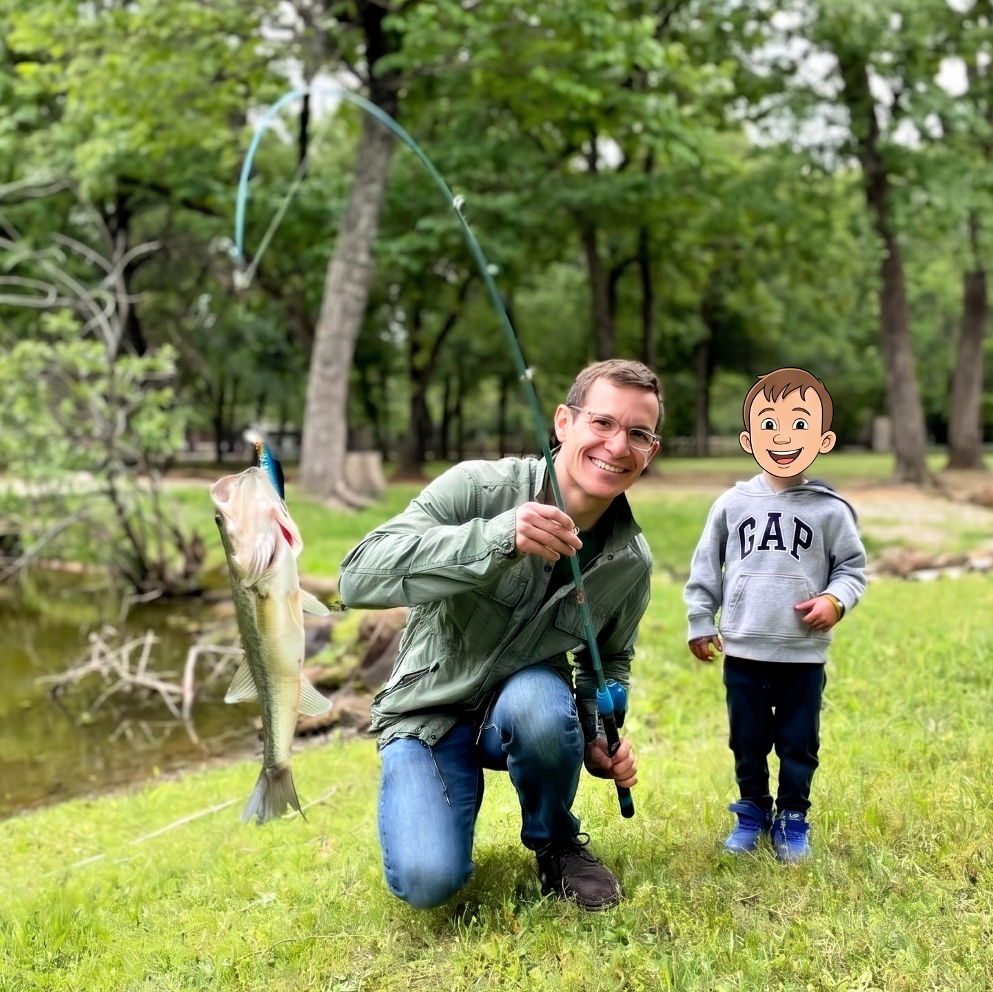 Dr. Derman and his young son fishing. They have caught a small fish and both are smiling and looking at the camera. There is a pond and greenery in the background.